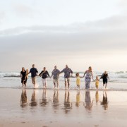 Large family group running at sunset on a sedgefield beach photoshoot