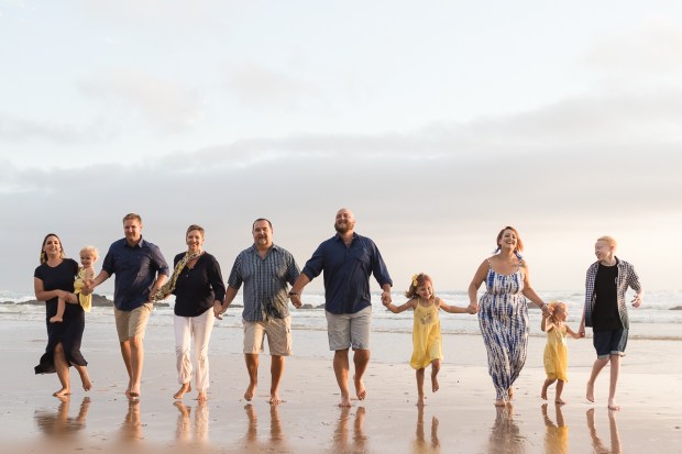 Large family group running at sunset on a sedgefield beach photoshoot 