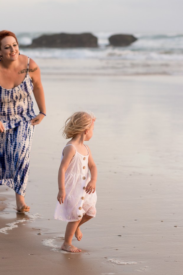 Mom chasing daughter at sunset during a Sedgefield beach photoshoot 