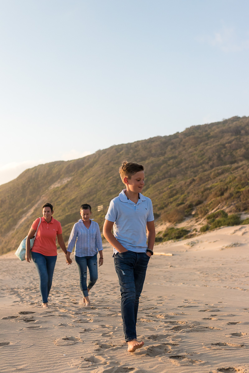 two mothers and their son playing on a beach at sunset in Sedgefield garden route during a photoshoot by moi du toi photography