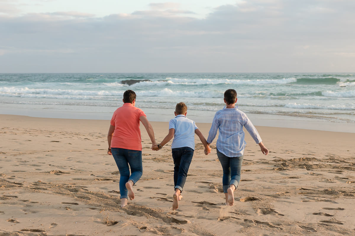 two mothers and their son playing on a beach at sunset in Sedgefield garden route during a photoshoot by moi du toi photography