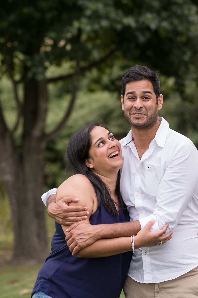 Brother and sister laughing during outdoor photoshoot at Fancourt George