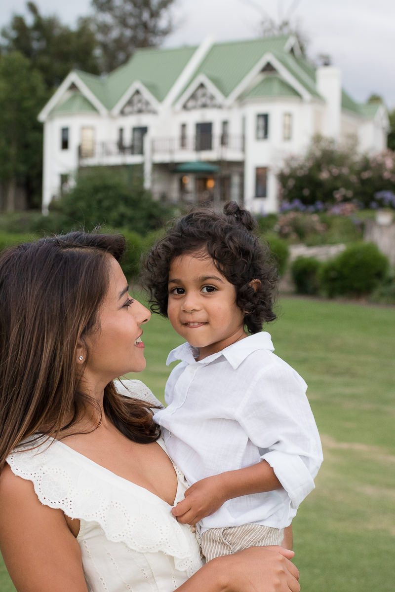 Mother holding little boy during family photoshoot at Fancourt George