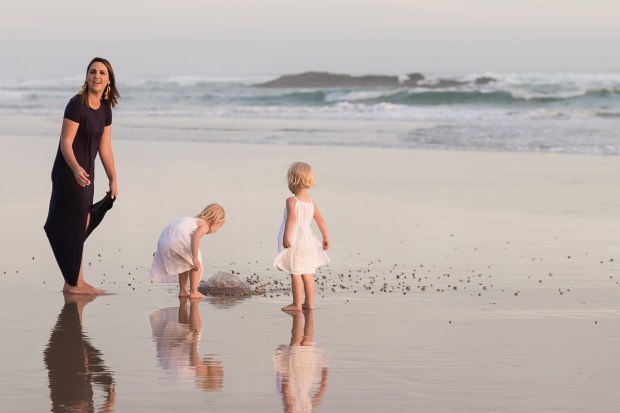 Woman and two little girls playing on beach sedgefield beach photoshoot