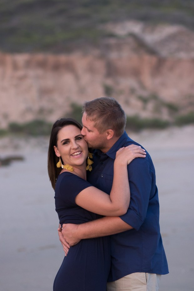 Man kissing woman sedgefield beach photoshoot