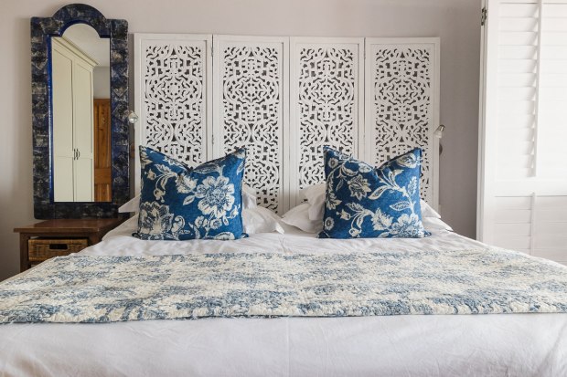 Stylish double bed in blue and white colours at Cola Beach guest house sedgefield