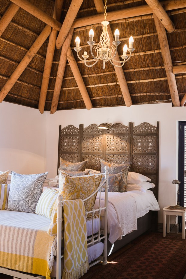 Stylish double bed in thatch roof bedroom at Cola Beach guest house sedgefield