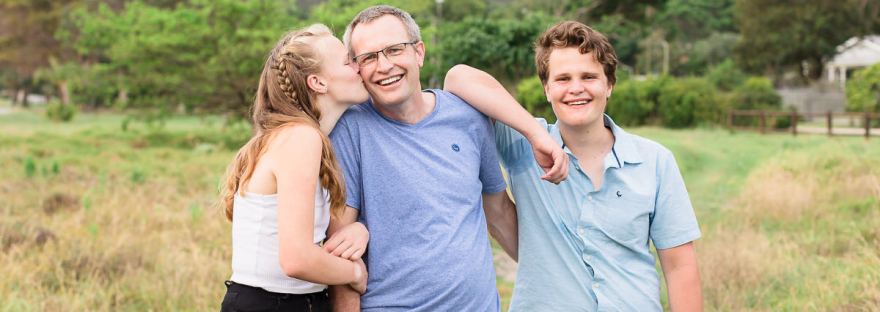 Girl kissing Dad on cheek during family photoshoot sedgefield knysna garden route