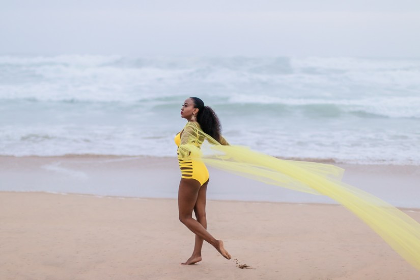 fashion model posing on myoli beach sedgefield during a sunset photoshoot by photographer moira du toit