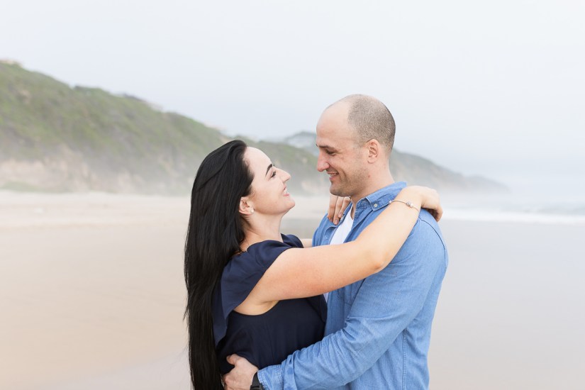 woman hugging man during light and airy family session at Cola Beach sedgefield photographer moi du toi