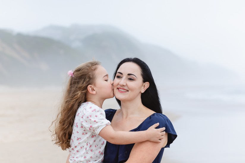daughter kissing mom during light and airy beach family session at Cola Beach sedgefield photographer moi du toi