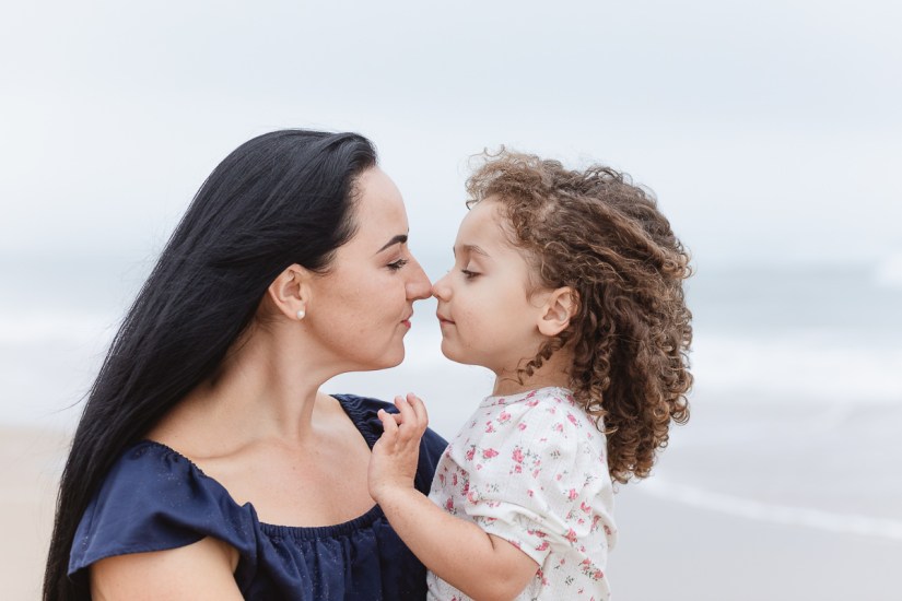 family playing on beach during light and airy family session at Cola Beach sedgefield photographer moi du toi