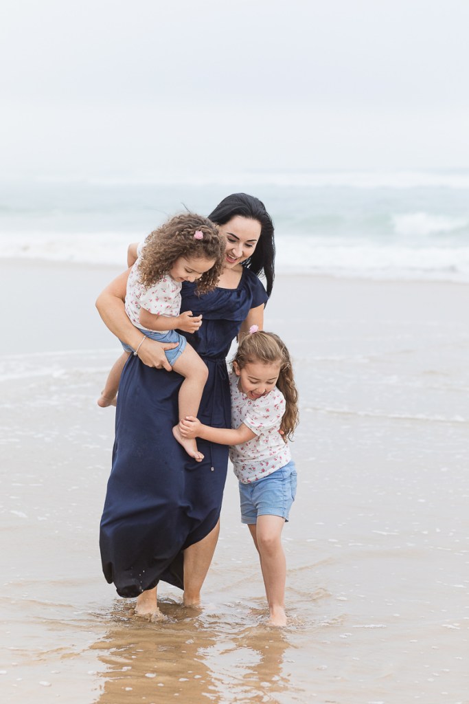 family playing on beach during light and airy family session at Cola Beach sedgefield photographer moi du toi