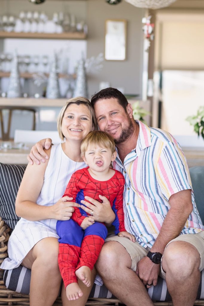 Little boy sticking out his tongue during light and airy slice of life family session at Cola Beach by sedgefield photographer moi du toi